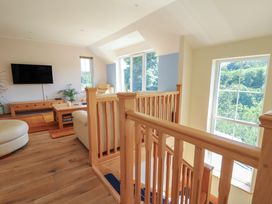 A living room with a television and coffee table at 1 Bryn Beudy in Stepaside