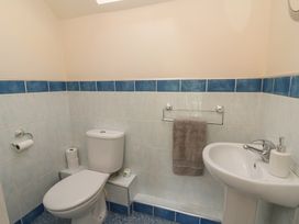 A bathroom with a toilet and sink at 1 Bryn Beudy Stepaside