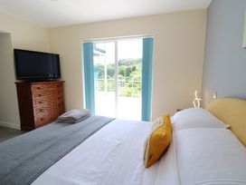 A bedroom with a bed and television at 1 Bryn Beudy in Stepaside