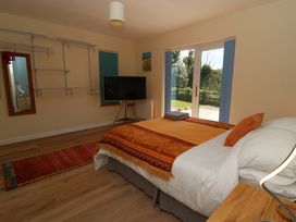 A bedroom with a bed and television at 1 Bryn Beudy Stepaside