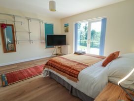 A bedroom with a bed and television at 1 Bryn Beudy in Stepaside