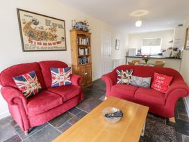 A living room with two sofas and a coffee table at 3 Riverside Bungalows Llanbedr