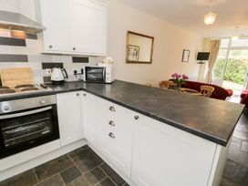 A kitchen with appliances and cooking area at 3 Riverside Bungalows in Llanbedr