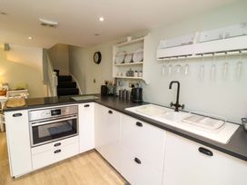 A kitchen with an oven and sink at Sea Sanctuary