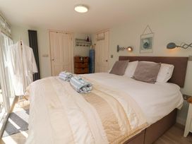 A bedroom with a bed and pillows at Sea Sanctuary