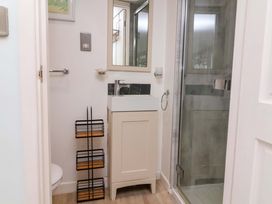 A bathroom with a sink and shower at Sea Sanctuary