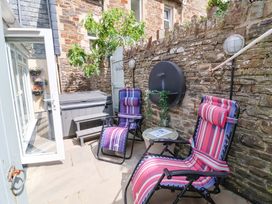 An outdoor seating area with chairs, a hot tub, and plants at Sea Sanctuary in 