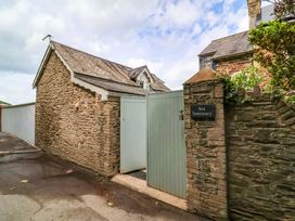 An entrance with a gate and stone wall at Sea Sanctuary
