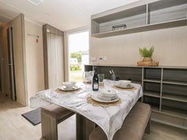 A dining room with a table set for a meal at Pinewood in Kidlington