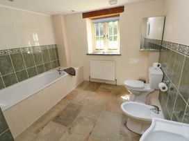A bathroom with a bathtub, toilet, bidet and sink at Carreg Las in Haverfordwest