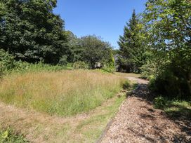 A garden area with a pathway and trees at Carreg Las Haverfordwest