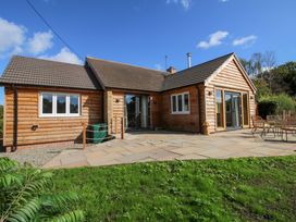 A wooden house with patio and garden at Dingle in Cleobury Mortimer