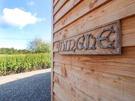 A wooden sign with the name Dingle at Dingle in Cleobury Mortimer