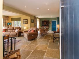 A living room with a sofa and dining table at Dingle in Cleobury Mortimer