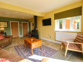 A living room with a coffee table and sofa at Dingle in Cleobury Mortimer