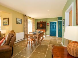A dining room with a table and chairs at Dingle in Cleobury Mortimer