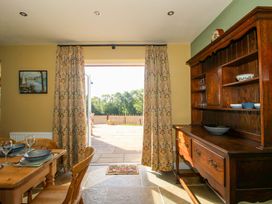A dining room with a view of the patio at Dingle in Cleobury Mortimer