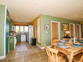 A kitchen with a dining table and chairs at Dingle in Cleobury Mortimer