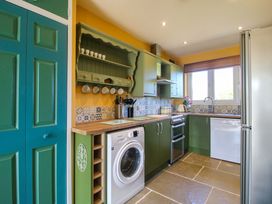 A kitchen with appliances and cabinets at Dingle in Cleobury Mortimer