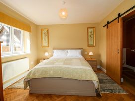 A bedroom with a bed and nightstand at Dingle in Cleobury Mortimer
