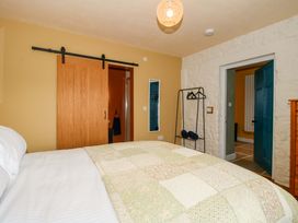 A bedroom with a bed and a coat rack at Dingle in Cleobury Mortimer