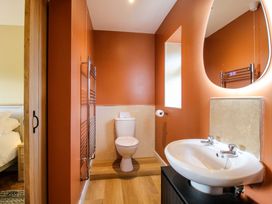 A bathroom with a toilet and sink at Dingle in Cleobury Mortimer