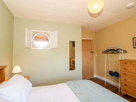 A bedroom with a bed and lamp at Dingle in Cleobury Mortimer
