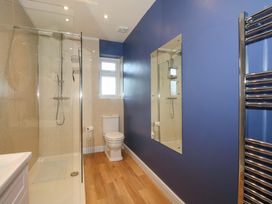 A bathroom with a shower and toilet at Dingle in Cleobury Mortimer