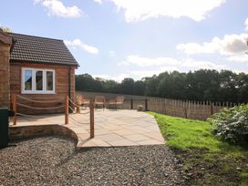 An outdoor area with a patio and seating at Dingle in Cleobury Mortimer