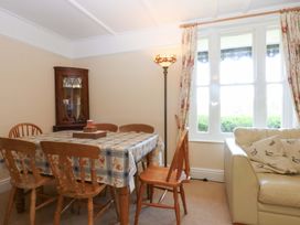 A dining room with a table and chairs at Disgwylfa in Sarn Mellteyrn