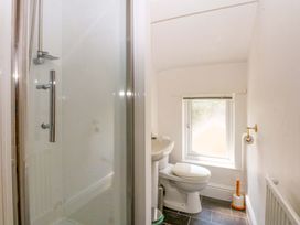 A bathroom with a shower, toilet, and sink at Disgwylfa in Sarn Mellteyrn