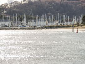 A marina with boats and hills in the background at Flat 1A, Mona House in Conwy