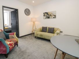 A living room with a sofa and armchair at Flat 1, Mona House Conwy