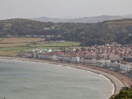 A coastal town with buildings along the beach at Flat 1, Mona House Conwy