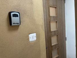 An entryway with a lockbox and a door at Hayes Lodge Coach House in Chulmleigh