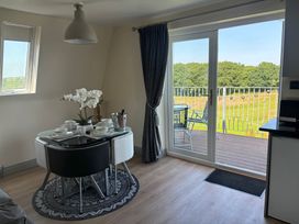 A dining room with a table set for a meal at Hayes Lodge Coach House in Chulmleigh