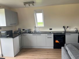 A kitchen with a sink and appliances at Hayes Lodge Coach House in Chulmleigh