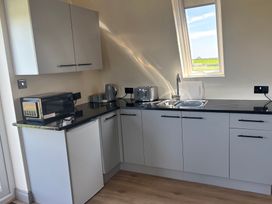 A kitchen with a sink and appliances at Hayes Lodge Coach House in Chulmleigh
