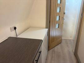 A utility room with a countertop and a door at Hayes Lodge Coach House, Chulmleigh