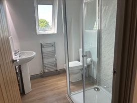 A bathroom with a sink, toilet, and shower at Hayes Lodge Coach House Chulmleigh