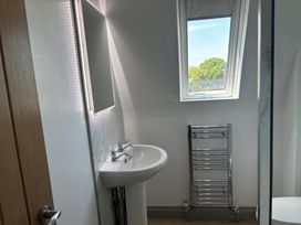 A bathroom with a sink and towel radiator at Hayes Lodge Coach House Chulmleigh