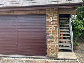 A garage door and staircase at Hayes Lodge Coach House in Chulmleigh