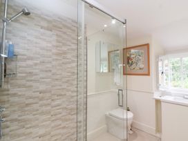 A bathroom with a shower, toilet, and sink at Magdalen Cottage in Hook Norton