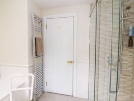 A bathroom with a shower and towel radiator at Magdalen Cottage in Hook Norton