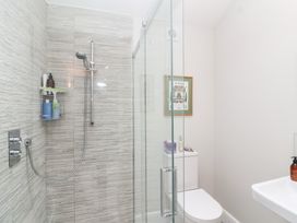 A bathroom with a shower, toilet, and sink at Magdalen Cottage in Hook Norton