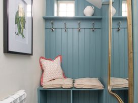An entryway with wall hooks and cushions at Apartment 1, 86 Dyer Street Cirencester