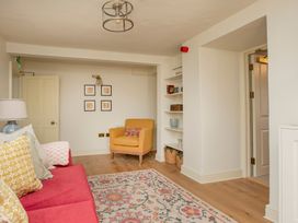 A living room with a sofa and an armchair at Apartment 1, 86 Dyer Street Cirencester