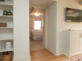 A bedroom view with a door and shelves at Apartment 1, 86 Dyer Street, Cirencester