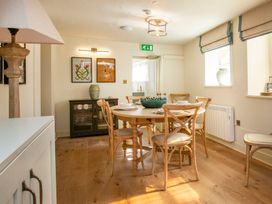 A dining room with a table and chairs at Apartment 1, 86 Dyer Street Cirencester