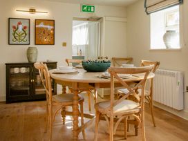 A dining room with a round table and four chairs at Apartment 1, 86 Dyer Street Cirencester